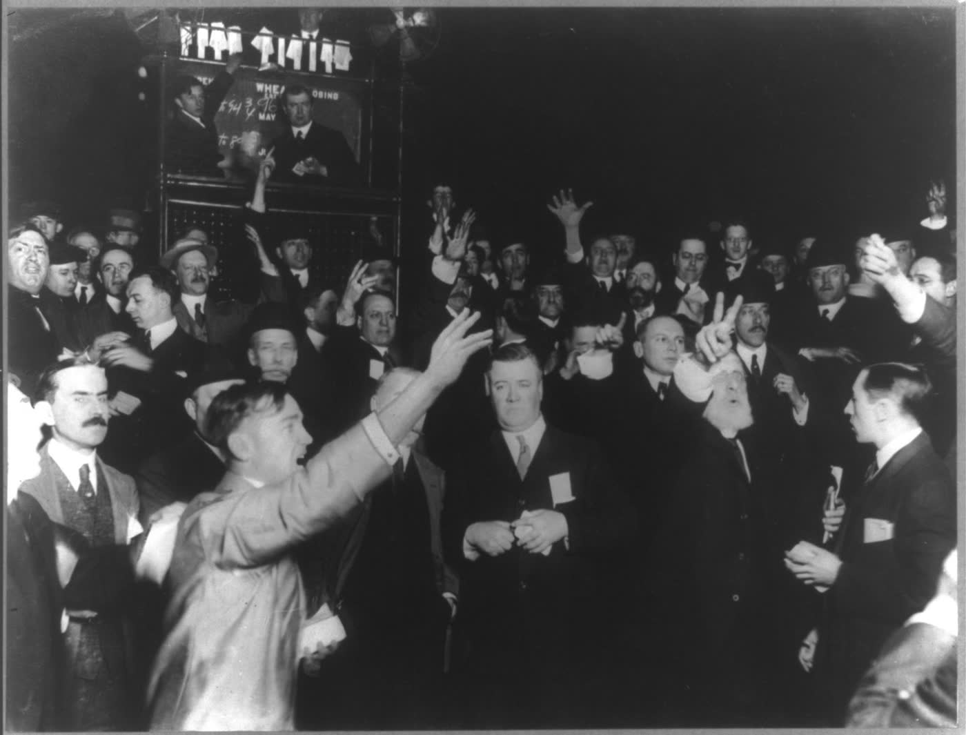 Traders with raised hands in the wheat pit of the Chicago Board of Trade, 1920
